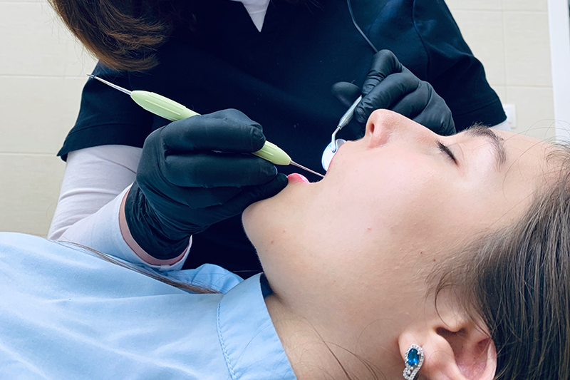 teeth-cleaning girl gets her teeth cleaned